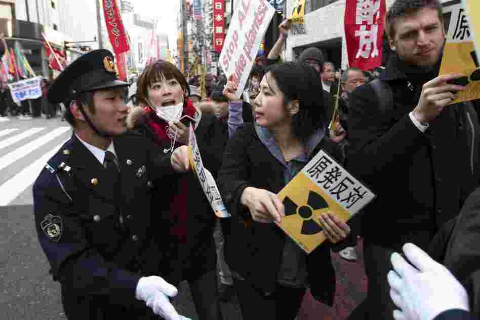 People confront police during an anti-war and anti-nuclear march in Tokyo. Hundreds of protesters marched for peace and against nuclear power, as plant workers continue their race to avert disaster at the tsunami-damaged Fukushima Dai-ichi nuclear power plant in the north. 