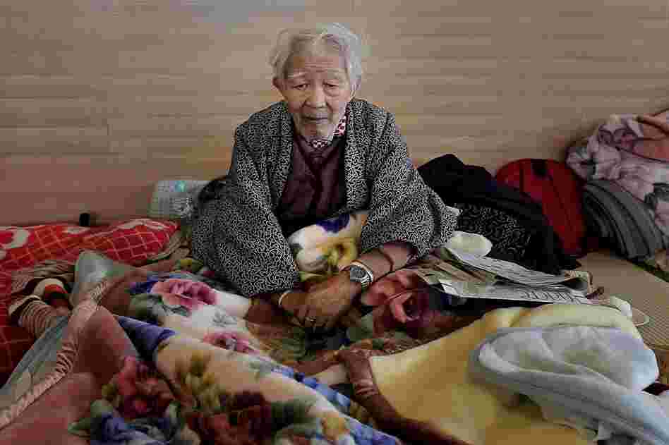 A man sits in an evacuation center in Rikuzentakata. 