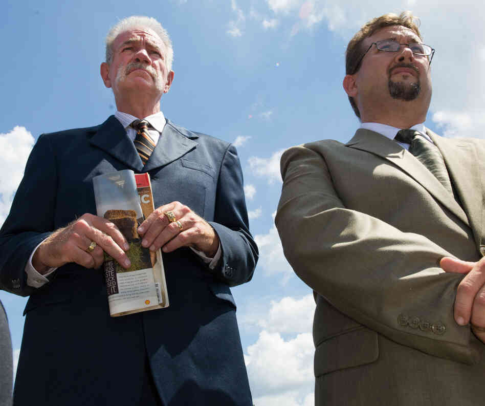 Pastors Terry Jones (L) and Wayne Sapp listen to reporter's questions on September 10, 2010 in Gainesville, Fla.