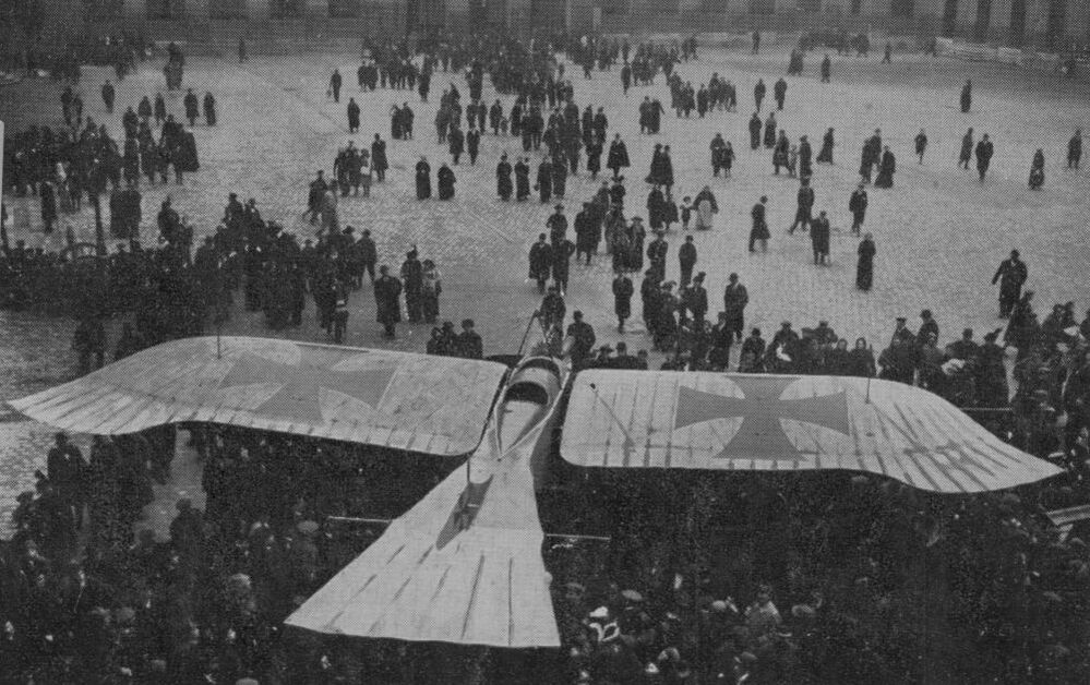 circa 1915:  Crowds gather to see a birdlike German 'Taube' aircraft, on display at Les Invalides, Paris, at the height of the First World War.
