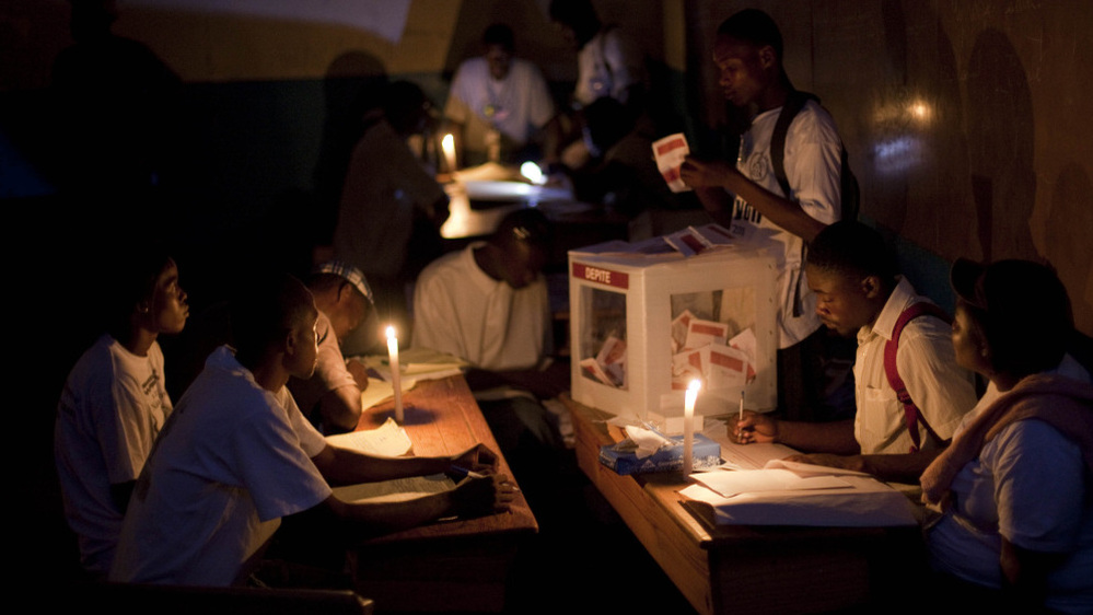 Electoral workers count ballots by candlelight at a polling station at the end of a presidential runoff in Port-au-Prince, Haiti, on Sunday. The two choices were Mirlande Manigat, the former first lady, and Michel "Sweet Micky" Martelly, a Haitian music star. Results are expected at the end of March.