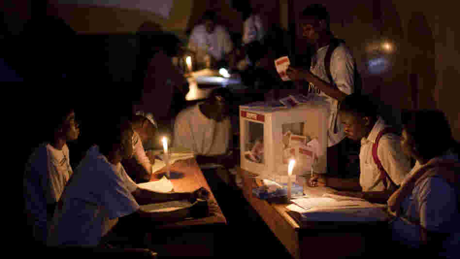 Electoral workers count ballots by candlelight at a polling station at the end of a presidential runoff in Port-au-Prince, Haiti, on Sunday. The two choices were Mirlande Manigat, the former first lady, and Michel "Sweet Micky" Martelly, a Haitian music star. Results are expected at the end of March.