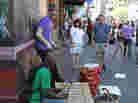 Percussionists Gidi Agbeko (green shirt) and Sam Bathrick (purple shirt) play on the street at SXSW in Austin on March 18, 2011.