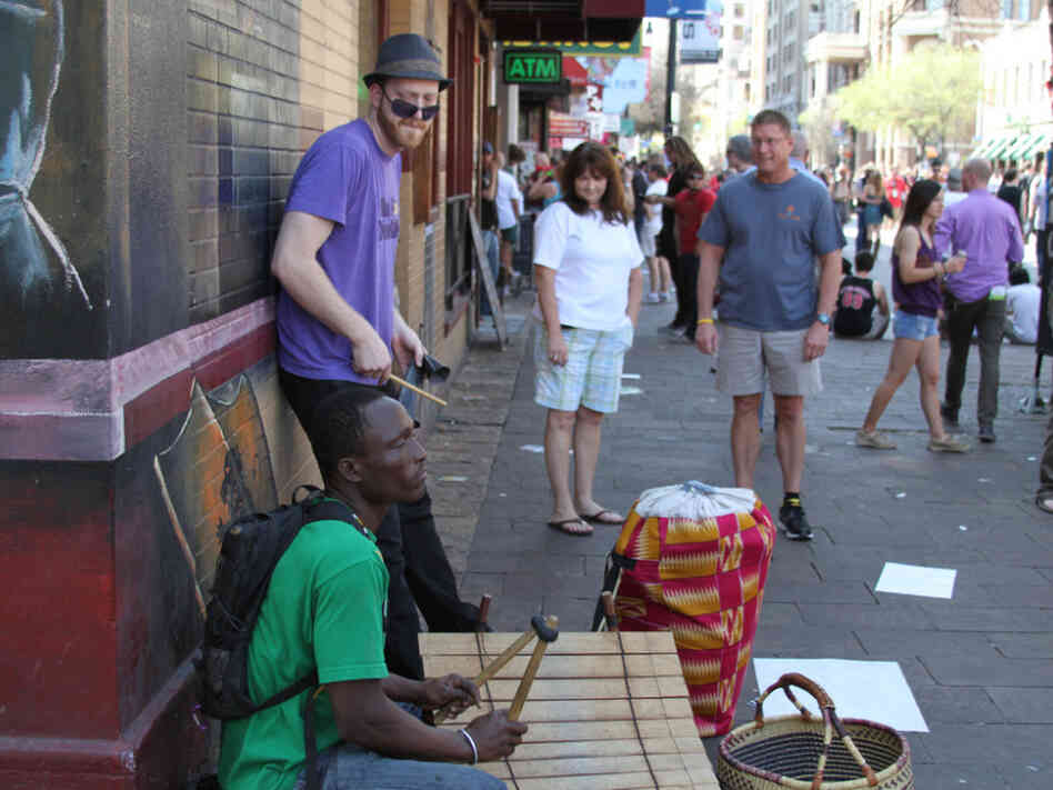 Percussionists Gidi Agbeko (green shirt) and Sam Bathrick (purple shirt) play on the street at SXSW in Austin on March 18, 2011. Percussionists Gidi Agbeko (green shirt) and Sam Bathrick (purple shirt) play on the street at SXSW in Austin on March 18, 2011.