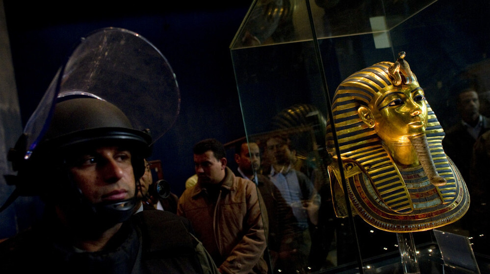 A soldier stands guard next to Tutankhamen's gold mask inside the Egyptian Museum on Feb. 16. Looters broke into the museum in Cairo's Tahrir Square in late January.