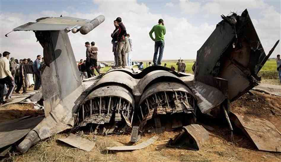 Libyans inspect the wreckage of a US F-15 fighter jet after it crashed east of Benghazi, Libya, Tuesday, March 22, 2011. Libyans inspect the wreckage of a US F-15 fighter jet after it crashed east of Benghazi, Libya, Tuesday, March 22, 2011.