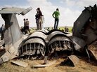 Libyans inspect the wreckage of a US F-15 fighter jet after it crashed east of Benghazi, Libya, Tuesday, March 22, 2011. Libyans inspect the wreckage of a US F-15 fighter jet after it crashed east of Benghazi, Libya, Tuesday, March 22, 2011.