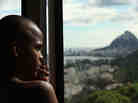 Devanil De Souza Jr. looks out over the recently pacified Santa Marta, one of Rio's oldest favelas. Arrival City points to Santa Marta as a migrant community that has been integrated into the larger city (and economy), as the state recently gave its residents the same benefits (street names, birth certificates, soccer fields, WiFi, garbage collection, etc.) that wealthier residents enjoy. Devanil De Souza Jr. looks out over the recently pacified Santa Marta, one of Rio's oldest favelas. Arrival City points to Santa Marta as a migrant community that has been integrated into the larger city (and economy), as the state recently gave its residents the same benefits (street names, birth certificates, soccer fields, WiFi, garbage collection, etc.) that wealthier residents enjoy.