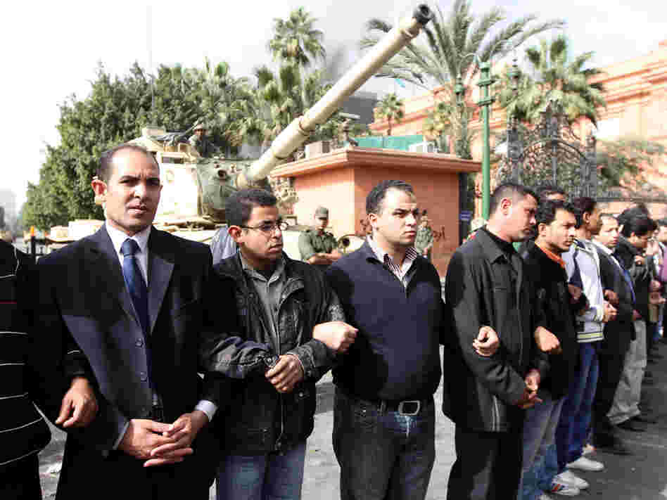 Egyptians make a human chain in Tahrir Square on Jan. 29 as they help protect Cairo's Egyptian Museum during demonstrations demanding the ouster of President Hosni Mubarak. Egyptians make a human chain in Tahrir Square on Jan. 29 as they help protect Cairo's Egyptian Museum during demonstrations demanding the ouster of President Hosni Mubarak.