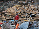 Earlier today in Minamisanriku, Miyagi prefecture, a woman walked through rubble.