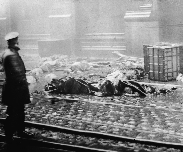 The Aftermath: A policeman stands in the street below the factory after the fire. The tragedy led to legislative reforms on a national level and spurred support for organized labor.
