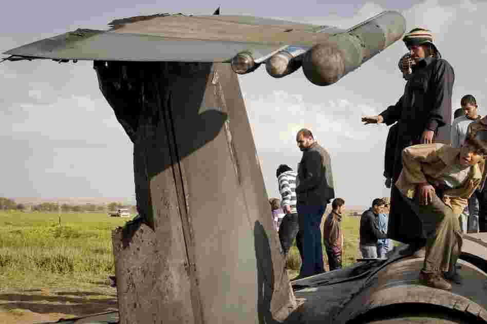 Libyans inspect the wreckage of a US  F-15 fighter jet after it crashed in an open field 25 miles southwest of the eastern rebel stronghold of Benghazi, Libya's second-largest city. 