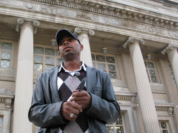 Herman Rainey, the Safe Passage coordinator for Leave No Veteran Behind, waits outside Chicago's Hyde Park Academy High School just before dismissal time.