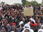 Ivorian women protest on an Abidjan street with a poster reading "Gbagbo you were born from a woman. You are heartless. Go out." on March 8, 2011. Ivorian women protest on an Abidjan street with a poster reading "Gbagbo you were born from a woman. You are heartless. Go out." on March 8, 2011.