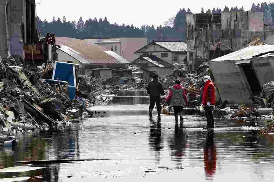 People search for the wreckage of their home in Kesennuma, Miyagi prefecture.  