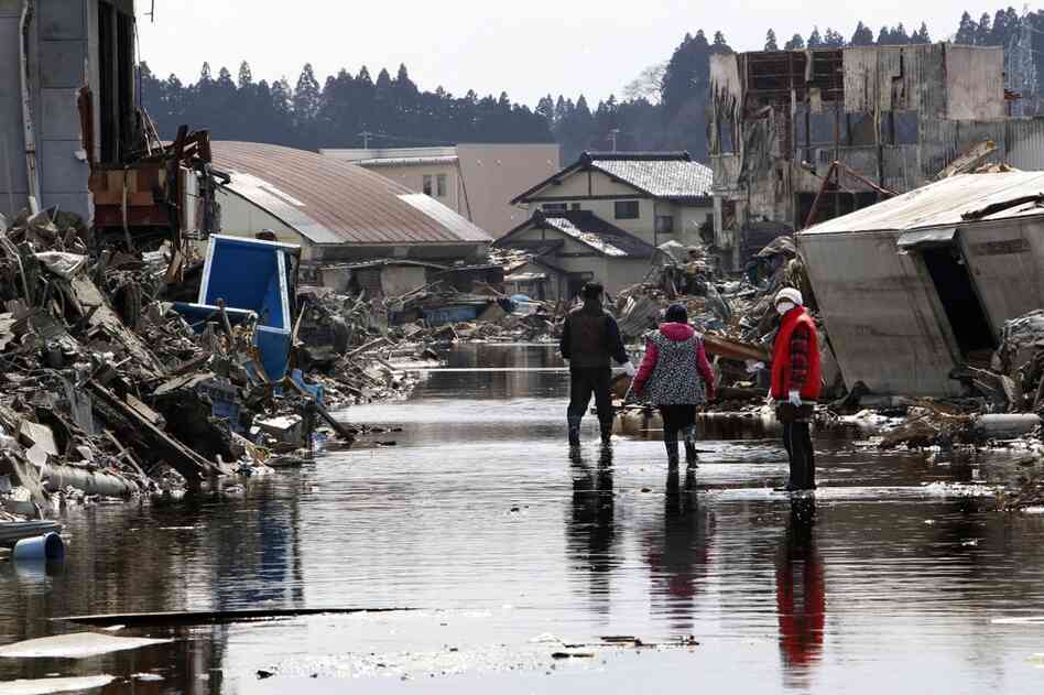 People search for the wreckage of their home in Kesennuma, Miyagi prefecture.  