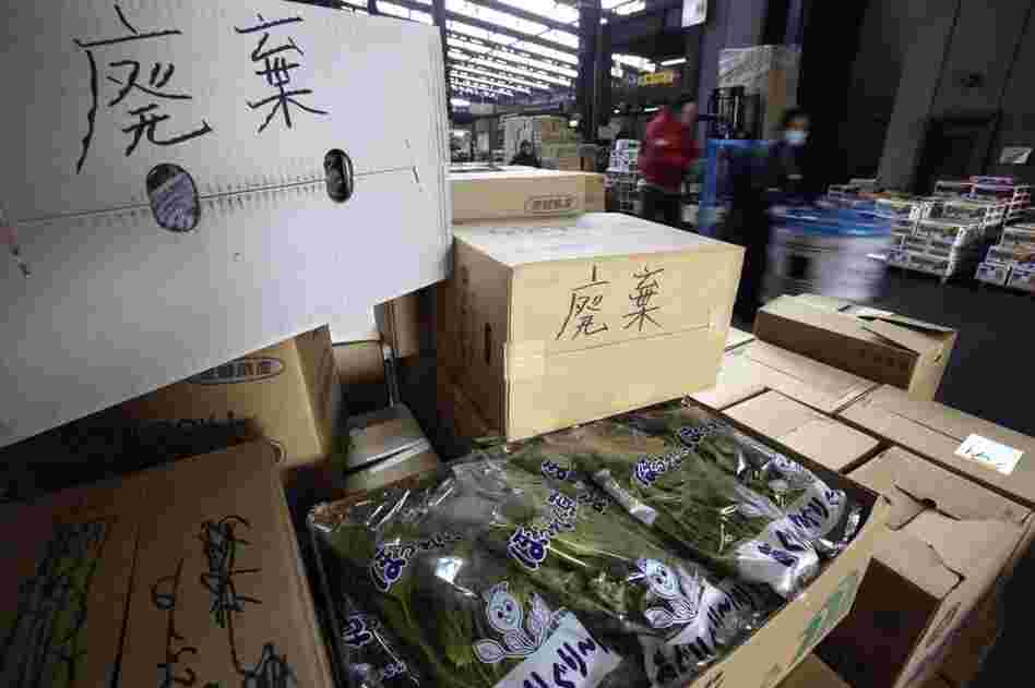 Boxes containing spinach and other products are left at a wholesale market in Tokyo after they were turned back from stores. Japan has banned sales of milk, spinach and a few other products from the region of the Fukushima Dai-ichi nuclear power plant. 