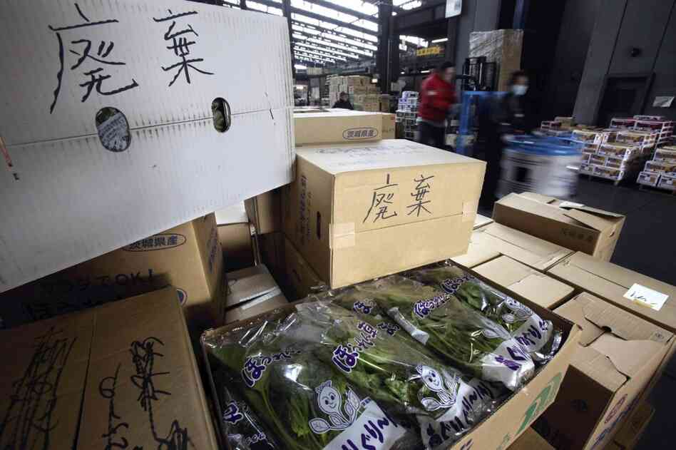Boxes containing spinach and other products are left at a wholesale market in Tokyo after they were turned back from stores. Japan has banned sales of milk, spinach and a few other products from the region of the Fukushima Dai-ichi nuclear power plant. 