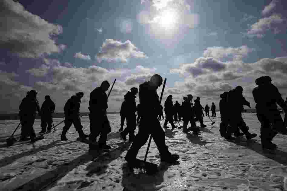 U.S. Navy crew members prepare to remove radioactive contamination from the flight deck of the aircraft carrier USS Ronald Reagan in the Pacific Ocean off Japan after 10 days of transporting supplies to survivors in the earthquake- and tsunami-devastated area. 