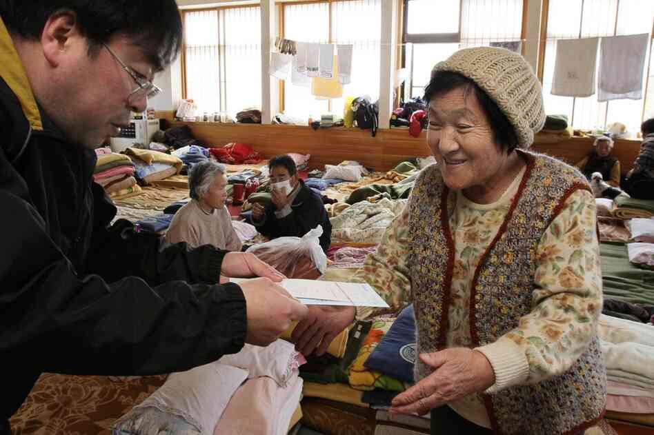 An evacuee receives mail at a shelter in Miyako. 
