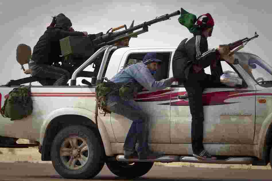 Libyan rebels retreat as mortars from Moammar Gadhafi's forces are fired on them on the outskirts of the city of Ajdabiya, south of Benghazi, eastern Libya, on Tuesday.
