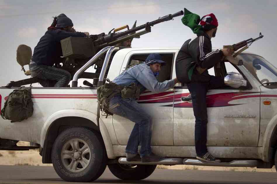 Libyan rebels retreat as mortars from Moammar Gadhafi's forces are fired on them on the outskirts of the city of Ajdabiya, south of Benghazi, eastern Libya, on Tuesday.