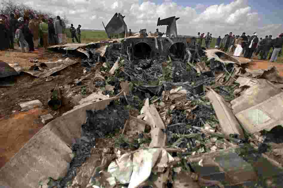 Libyans gather around the wreckage of a US F-15 fighter jet after crashing while on a mission against Gadhafi's air defences. 