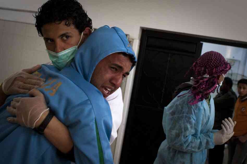 A Libyan man cries after identifying his brother at the morgue of the Jalaa hospital in Benghazi. His brother died during fighting around the city of Ajdabiya on Tuesday. 