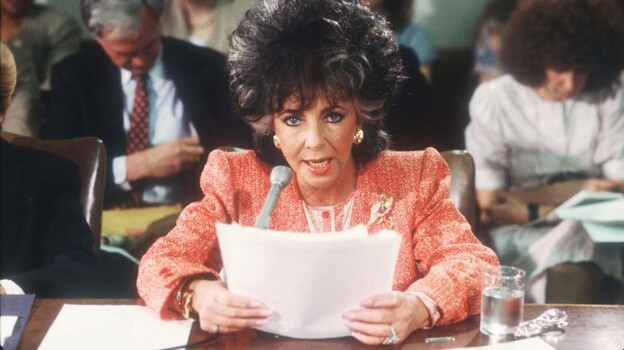 Elizabeth Taylor testifies before a U.S. Senate committee in 1986, after the death of close friend Rock Hudson in 1985.