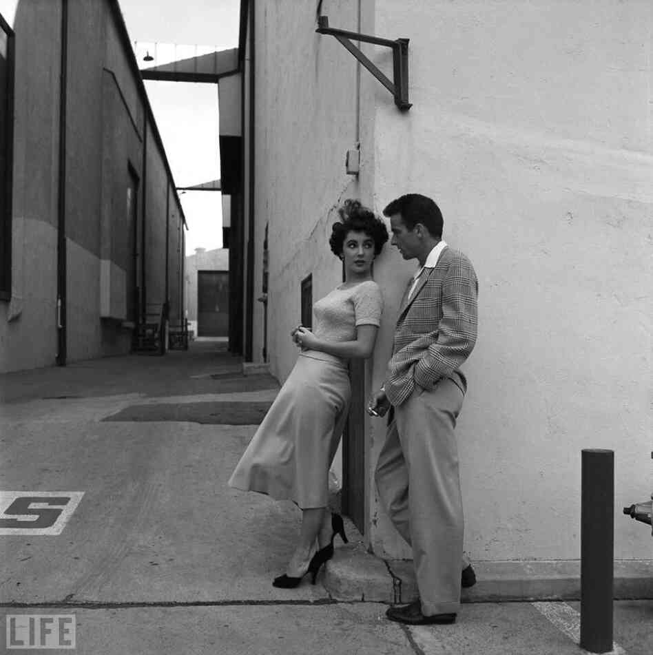 During a break in filming A Place in the Sun, Taylor chats with her costar Montgomery Clift on the Paramount lot. During a break in filming A Place in the Sun, Taylor chats with her costar Montgomery Clift on the Paramount lot.