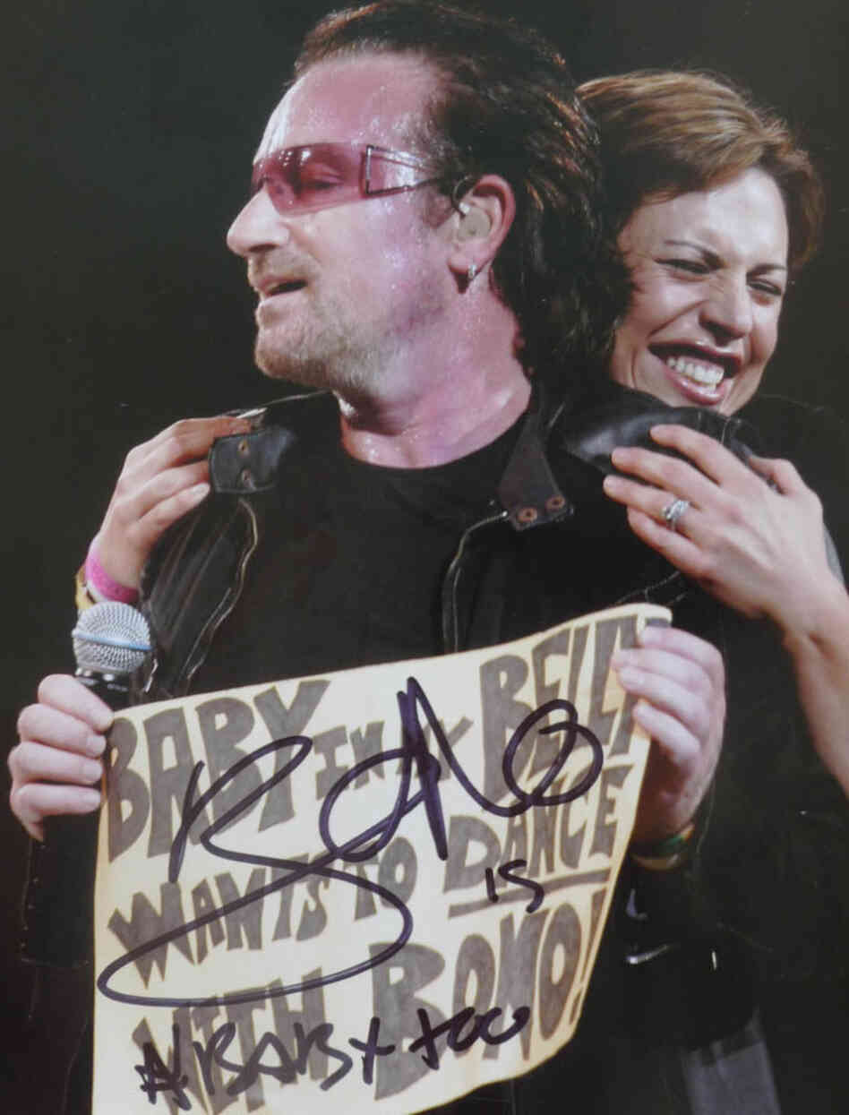 "Taken during the U2 Vertigo Tour in Boston, 2005. I was pulled onstage when Bono saw my sign: 'Baby in my Belly wants to Dance with Bono!' He recently signed the picture at a show during the U2 360 tour!"