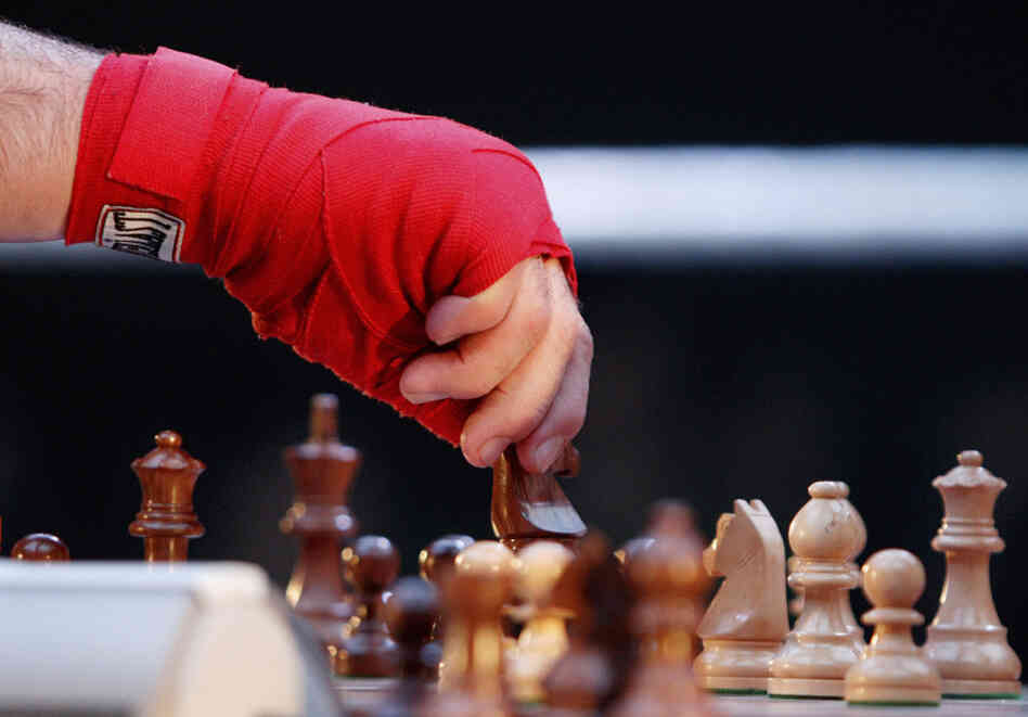 U.S. "chess boxer" David Depto moves a horse with his taped hand during a chess boxing world championship against German Frank Stoldt, organized by the World Chess Boxing Organization. U.S. "chess boxer" David Depto moves a horse with his taped hand during a chess boxing world championship against German Frank Stoldt, organized by the World Chess Boxing Organization.