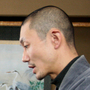 Japanese Buddhist monk Tanaka Tokuun, who was evacuated from Fukushima prefecture, looks over an instrument  measuring radiation levels at a hotel on March 17.