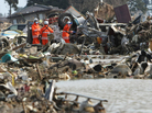 Rescue workers searched for missing people in Natori city, in Miyagi prefecture, earlier today (March 24, 2011).