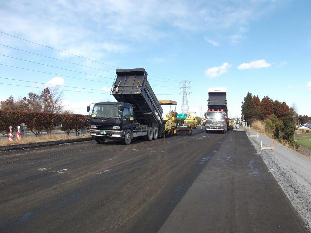 Road crews rebuild a highway damaged in the earthquake.