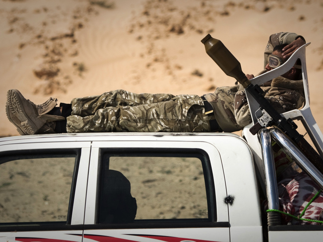 A Libyan rebel rests at a checkpoint on a front line near Zwitina, the outskirts of the city of Ajdabiya, south of Benghazi, in eastern Libya on March 24.