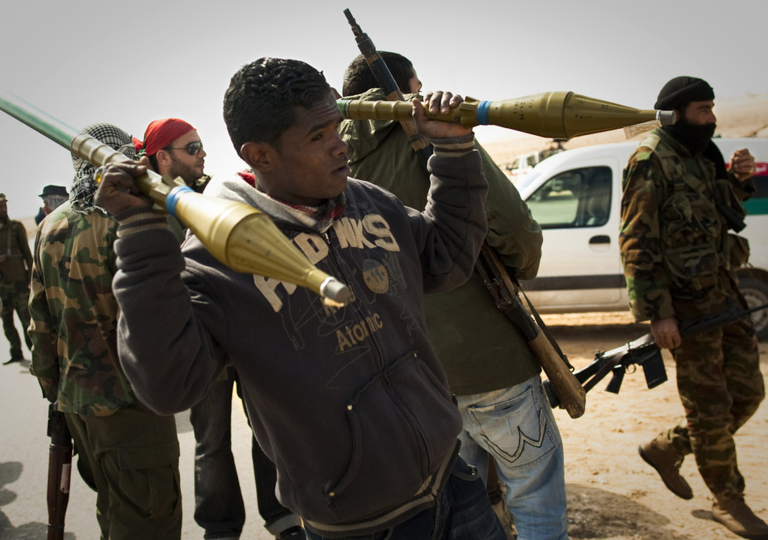 Rebels carry rockets on a checkpoint on the front line near Zwitina, the outskirts of the city of Ajdabiya, south of Benghazi, eastern Libya, on March 24.