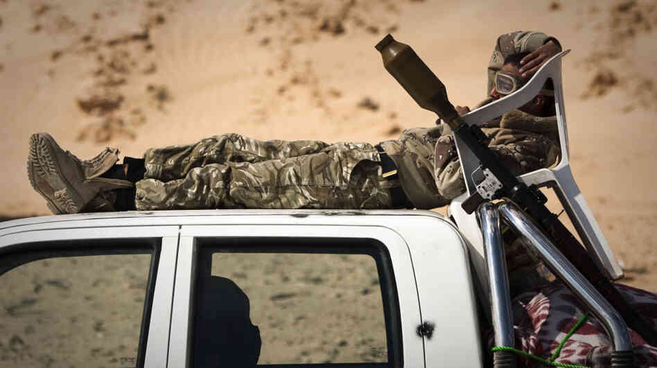 A Libyan rebel rests at a checkpoint on a front line near Zwitina, the outskirts of the city of Ajdabiya, south of Benghazi, in eastern Libya on March 24.