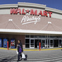 A woman makes her way out of a Wal-Mart store in Oakland, Calif. Wal-Mart is arguing that it is too big to be sued by 1.5 million of its current and former female workers. A woman makes her way out of a Wal-Mart store in Oakland, Calif. Wal-Mart is arguing that it is too big to be sued by 1.5 million of its current and former female workers.