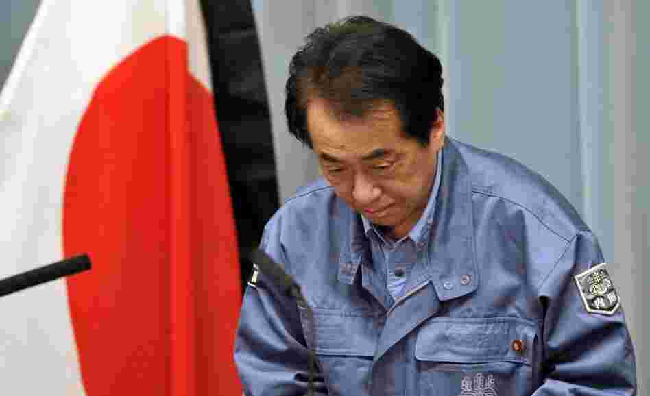 Japanese Prime Minister Naoto Kan bows as he holds a news conference in Tokyo on March 25, 2011.