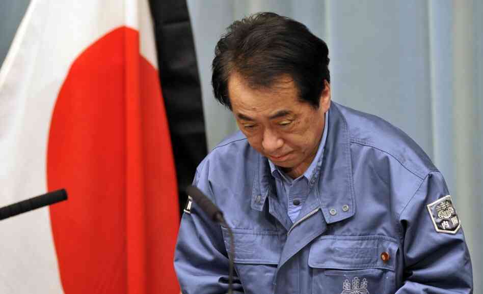 Japanese Prime Minister Naoto Kan bows as he holds a news conference in Tokyo on March 25, 2011.