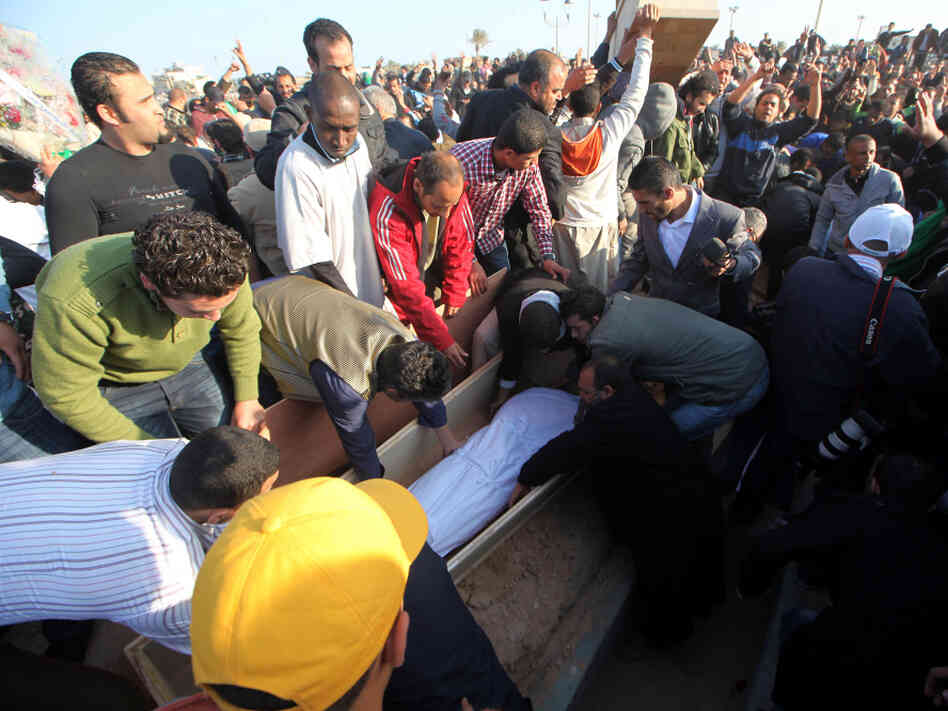 Libyans attend a mass funeral at the Shati al-Hinshir cemetery in Tripoli for people government officials say were killed in coalition attacks.