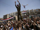 A Yemeni army officer is lifted by anti-government protestors in a demonstration against President Ali Abdullah Saleh, in Sanaa, Yemen, Thursday, March 24, 2011. A Yemeni army officer is lifted by anti-government protestors in a demonstration against President Ali Abdullah Saleh, in Sanaa, Yemen, Thursday, March 24, 2011.