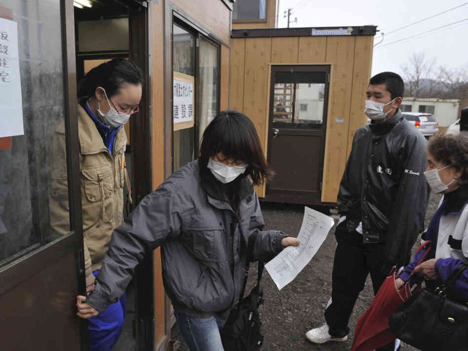Evacuees who lost their homes in the March 11 earthquake and tsunami visit a makeshift city hall to apply for temporary housing in Rikuzentakata, Japan.