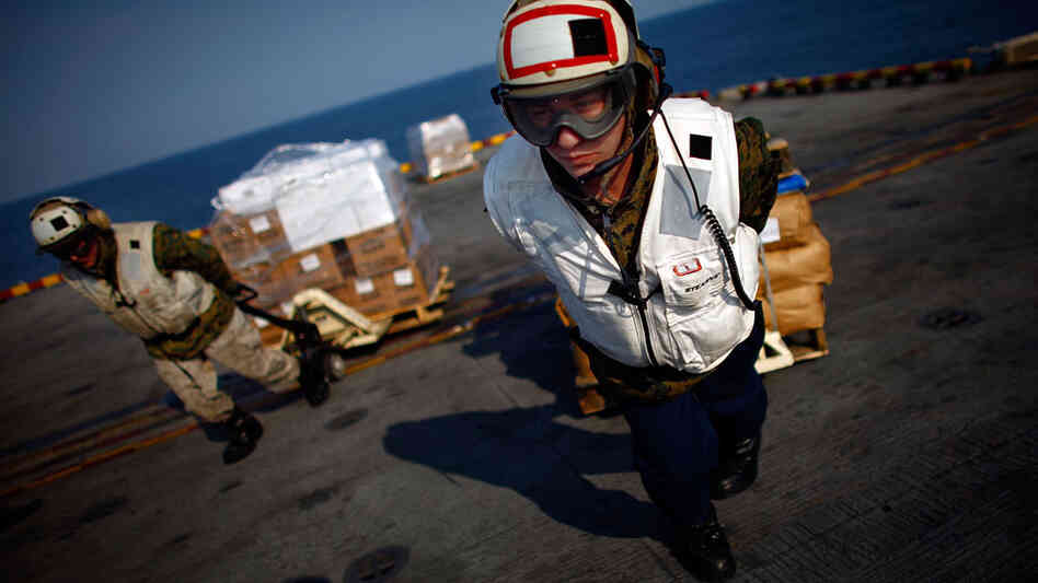 Marine Lance Cpl. Gregory Pollina pulls a pallet of relief supplies to a waiting helicopter aboard the USS Essex, which is conducting operations in support of Operation Tomodachi. The Marines and Navy are flying the much needed aid to the tsunami-devastated northeast coast of Japan. Marine Lance Cpl. Gregory Pollina pulls a pallet of relief supplies to a waiting helicopter aboard the USS Essex, which is conducting operations in support of Operation Tomodachi. The Marines and Navy are flying the much needed aid to the tsunami-devastated northeast coast of Japan.