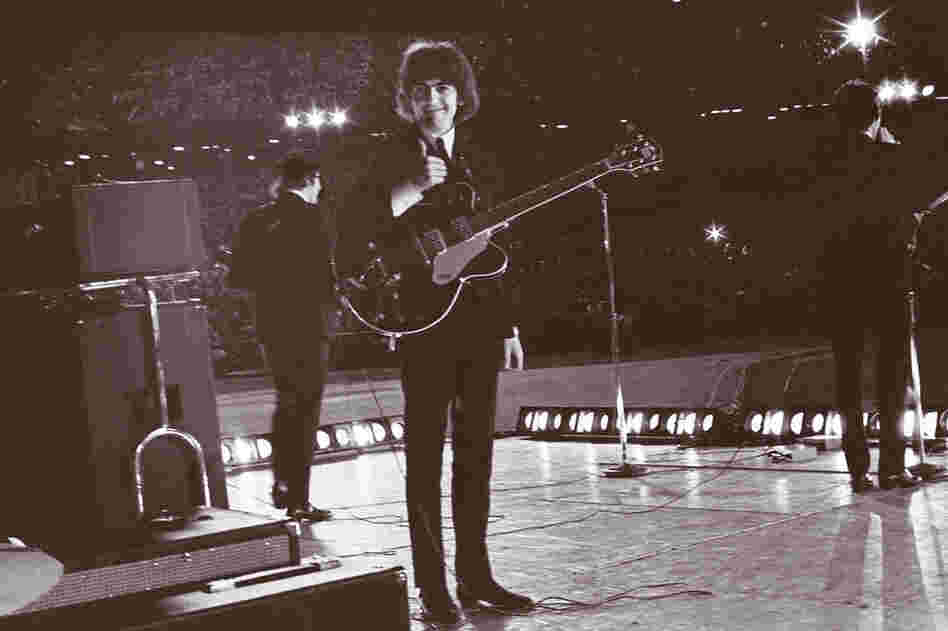 From the stage at Metropolitan Stadium in Bloomington, Minn., George Harrison turns to see Bob Bonis with his camera and gives him a thumbs up. Aug. 21, 1965.