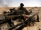 A Libyan loyalist army tank burns in the town of Ajdabiya on March 26, 2011.