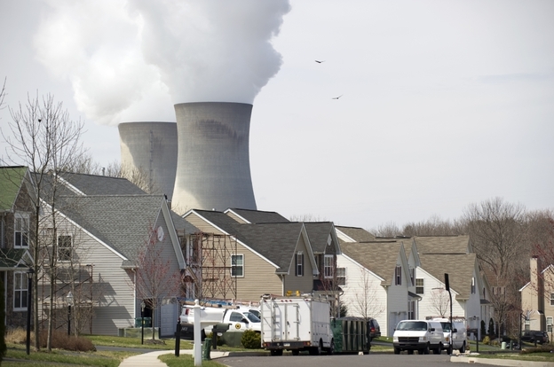 Cooling towers from the Limerick Generating Station, a nuclear power plant in  Pottstown, Pa., sit near a neighborhood. Environmentalists agree that in light of Japan's nuclear crisis, the U.S. should examine existing nuclear plants for safety risks.