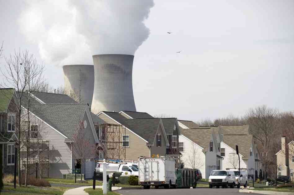 Cooling towers from the Limerick Generating Station, a nuclear power plant in  Pottstown, Pa., sit near a neighborhood. Environmentalists agree that in light of Japan's nuclear crisis, the U.S. should examine existing nuclear plants for safety risks.