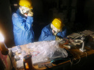 Workers look at charts inside a darkened control room at the Fukushima Dai-ichi nuclear power plant. Workers look at charts inside a darkened control room at the Fukushima Dai-ichi nuclear power plant.